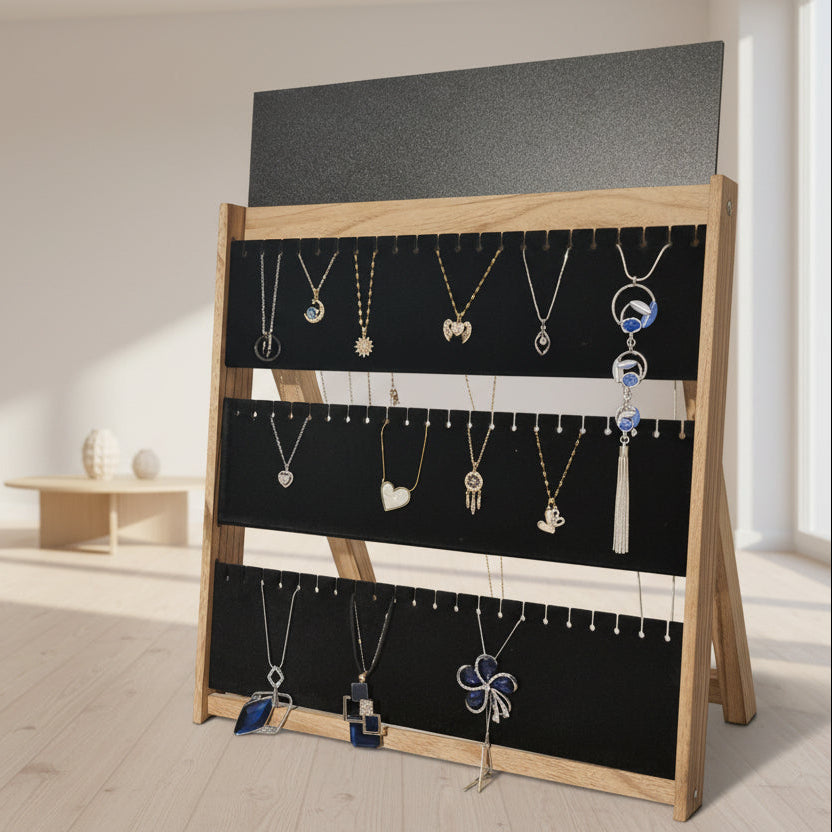 Jewelry display with various necklaces on a black board